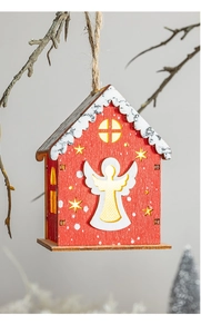 Detail of red wooden Christmas house ornament with warm LED light and angel silhouette