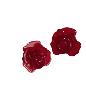 Fashionable red multi-layered rose flower earrings with shiny resin finish on white background