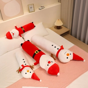Detail of plush Santa and Snowman body pillows on bed with warm festive bedroom decor