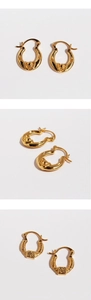Detailed views of gold U-shaped earrings featuring vintage embossed floral textures