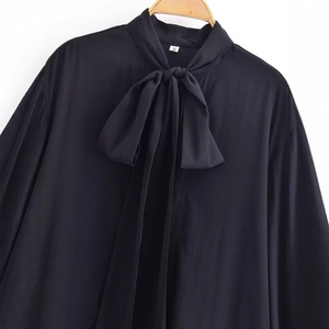 Elegant black long-sleeve blouse featuring a decorative bow tie collar and silky texture