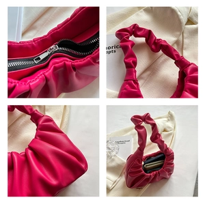 Detailed views of magenta pleated bag with silver zipper and cloud texture finish