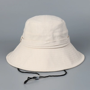 Detail of adjustable windproof drawstring and fabric texture on wide brim cotton linen sun hat
