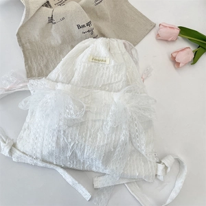 Detailed visual of the elegant white lace floral drawstring backpack for students
