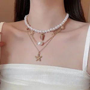 Multi-layer gold necklace with pearls, starfish and shell charms for beach vacations