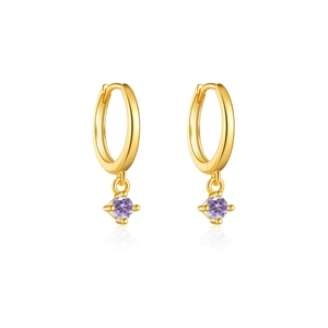 Detail of gold huggie earrings featuring round purple gemstone pendants in 4-prong setting