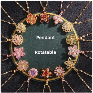 Close-up of rotating flower clover pendants with colorful zircon in gold finish