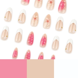 Pink almond press-on nails with 3D floral designs, pearls, and French tip patterns