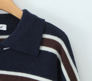 Close-up of the polo collar and striped knit texture on a navy and brown sweater