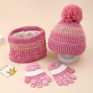 Close-up of pink gradient knit beanie with pom pom, fleece neck warmer and gloves set
