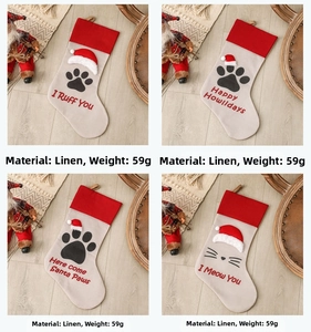 Linen Christmas pet paw stockings set with holiday decor on wooden floor detail