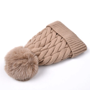 Close-up of khaki chunky cable knit beanie with fluffy pom-pom and ribbed cuff