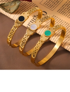 Detailed view of hollow chain bracelets with black onyx, white pearl, and green malachite
