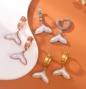 Detailed view of fishtail earrings in gold, silver, and rose gold with pearl inlay