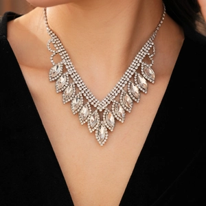 Detailed view of silver luxury V-shaped necklace with rhinestones worn by a model