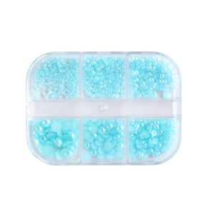 Light blue faux pearls in a 6-grid clear plastic storage box for nail art decoration
