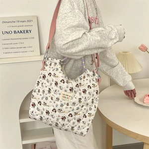 Détail du sac matelassé avec motifs de dessins animés et bandoulière rose souple