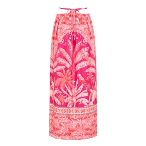 Detail of pink tropical print dress with palm leaves and parrot patterns for beach vacation