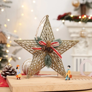 Detailed view of a gold glitter star tree topper with pine cones and striped ribbon