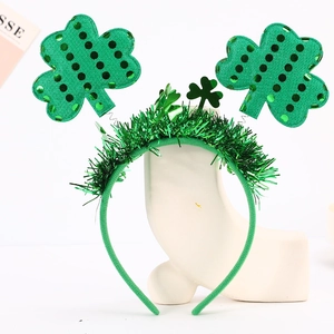 Detail of St. Patrick's Day headband with green sequins shamrocks and festive tinsel decor