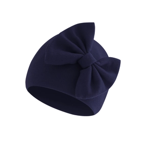 Detailed close-up of navy blue double-layer knitted baby hat with a large bow decoration