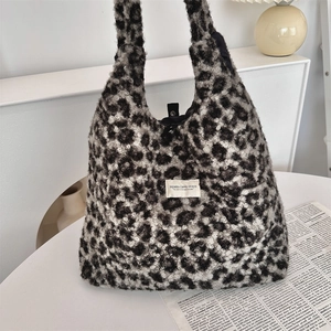 Detail showing plush leopard print texture and SOZAKKA brand label on a large tote bag