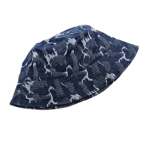 Detailed view of dark blue denim bucket hat with light blue abstract giraffe patterns