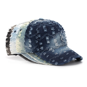 Detailed view of distressed denim textures and ripped edges on vintage baseball caps
