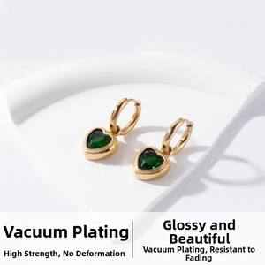 Detail of vacuum-plated gold heart earrings with deep green zircon and high durability
