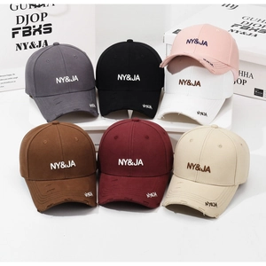 Detail shot of distressed cotton baseball caps with 3D NY&JA embroidery in multiple colors