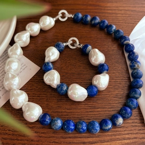 Baroque pearl and lapis lazuli jewelry set with necklace and bracelet on vintage wood