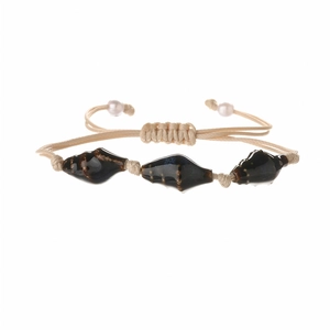 Bohemian adjustable braided bracelet featuring dark ceramic beads and white pearls