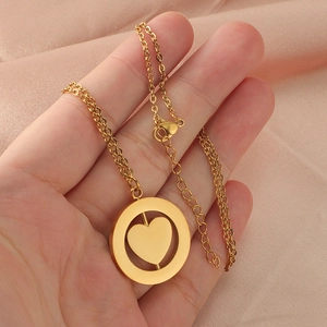 Elegant gold double-layer necklace with a rotatable heart pendant on pink silk