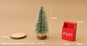 Miniature snow-dusted Christmas tree with red vintage post box and natural wood base