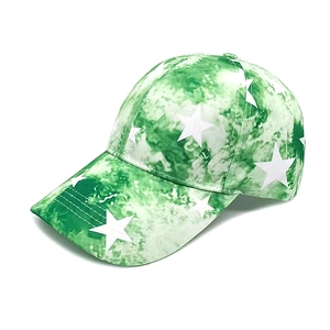 Detail of green and white tie-dye baseball cap featuring printed white pentagram stars