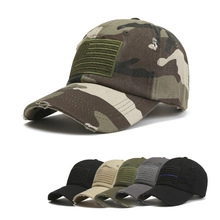 Detail of camouflage tactical baseball cap with flag patch and distressed brim design