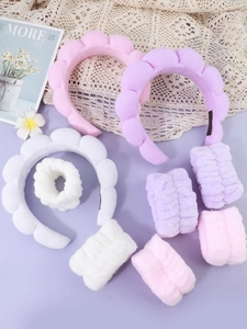 Detail of soft plush spa headbands and absorbent wristbands in pink, purple and white