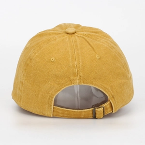 Detail view of mustard yellow washed cotton baseball cap with adjustable metal buckle