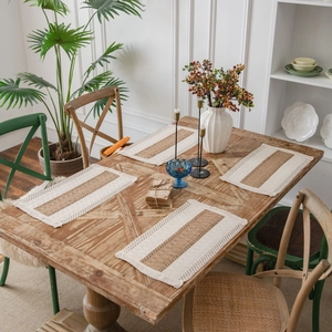 Set of 4 woven hemp placemats with bicolor stripes and fringe edge on a wood table