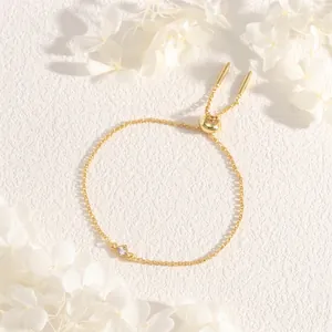 Macro detail of adjustable gold chain bracelet with a square clear zircon stone