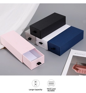 Detail view of drawer-style jewelry boxes in multiple colors with ribbon pull handles