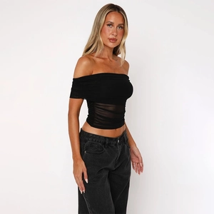 Detail of black mesh off-shoulder top with elegant pleats and slim fit silhouette