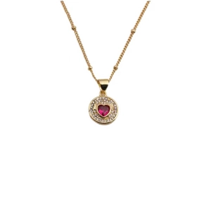 Gold pendant necklace featuring a red heart zircon with crystal pavé on a beaded chain