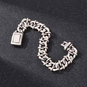Macro shot of retro silver infinity link bracelet with rugged chain detail and square clasp