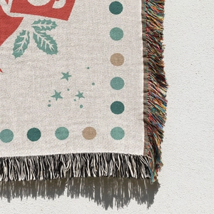 Close-up of woven Christmas tree blanket showing colorful fringe and jacquard texture