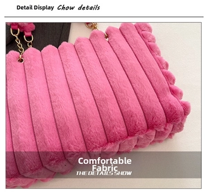 Close-up of pink plush tote bag showing soft quilted texture and gold metal chain strap