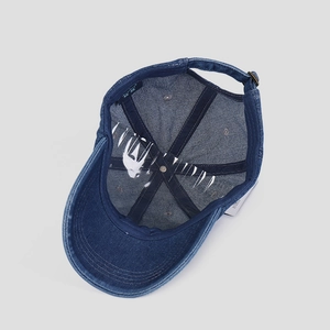 Detail view of denim baseball cap interior showing sweatband and reinforced stitching