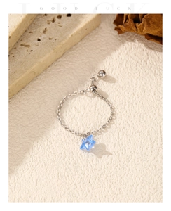 Macro detail of adjustable S925 silver ring with a sparkling blue star pendant charm