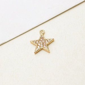 Macro shot of gold-plated star pendant with white zircon inlay for jewelry making
