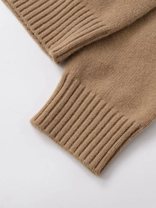 Close-up of thick ribbed cuffs and soft knit texture on this warm camel hoodie jacket